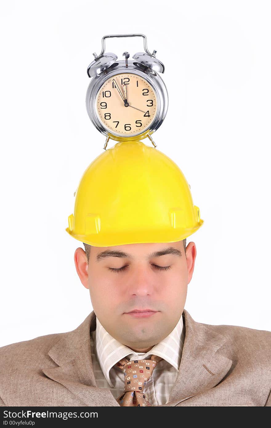 Sleepy businessman with clock alarm