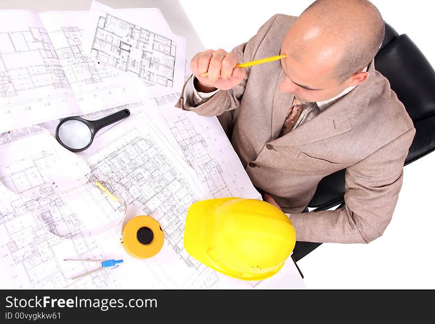 Businessman thinking with architectural plans on white background