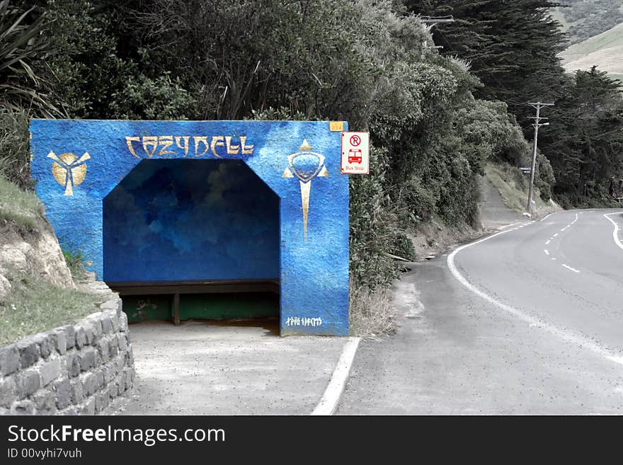 A brightly painted bus stop shelter in the country. A brightly painted bus stop shelter in the country