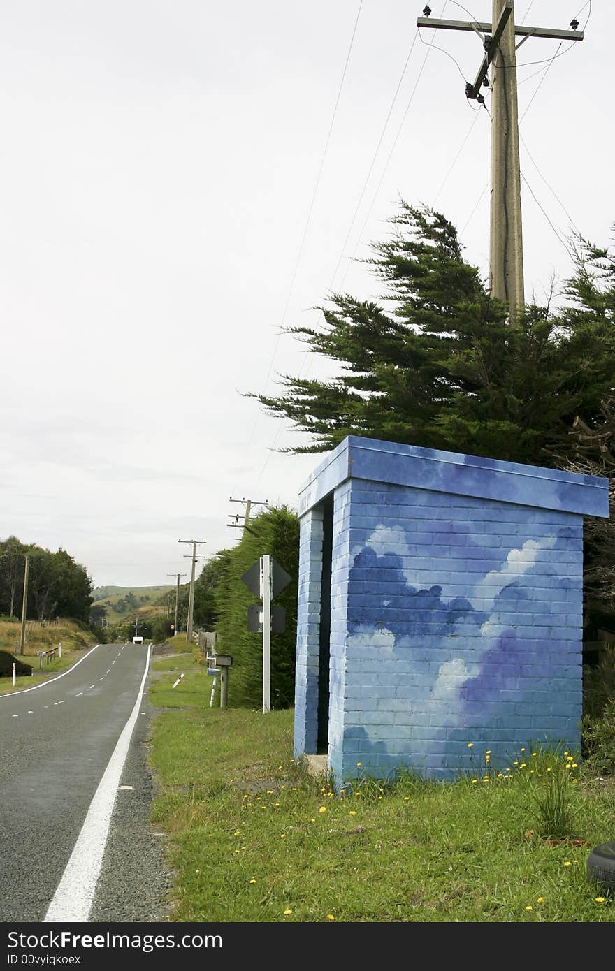 A brightly painted bus stop shelter in the country. A brightly painted bus stop shelter in the country