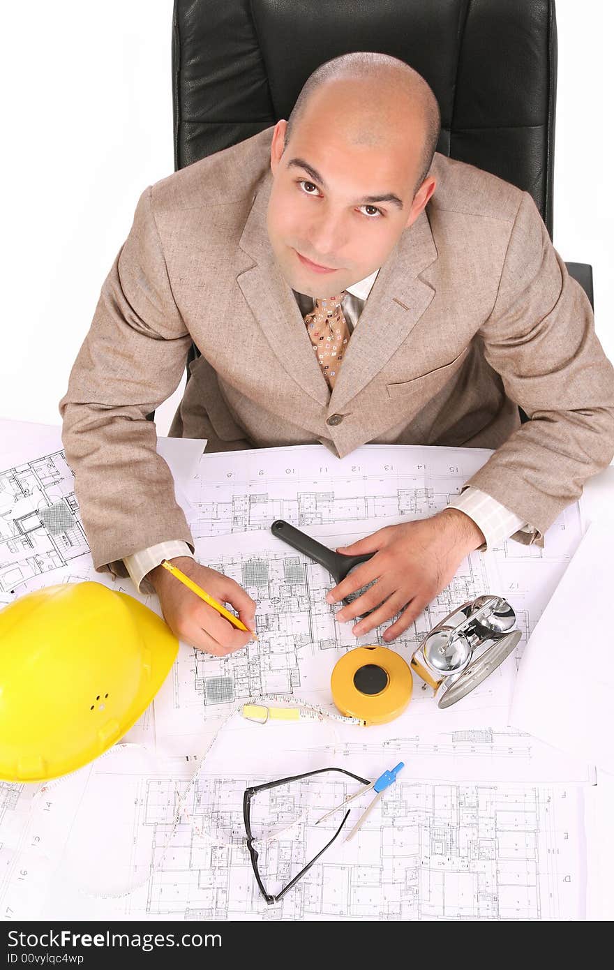 A businessman happiness with architectural plans at desk