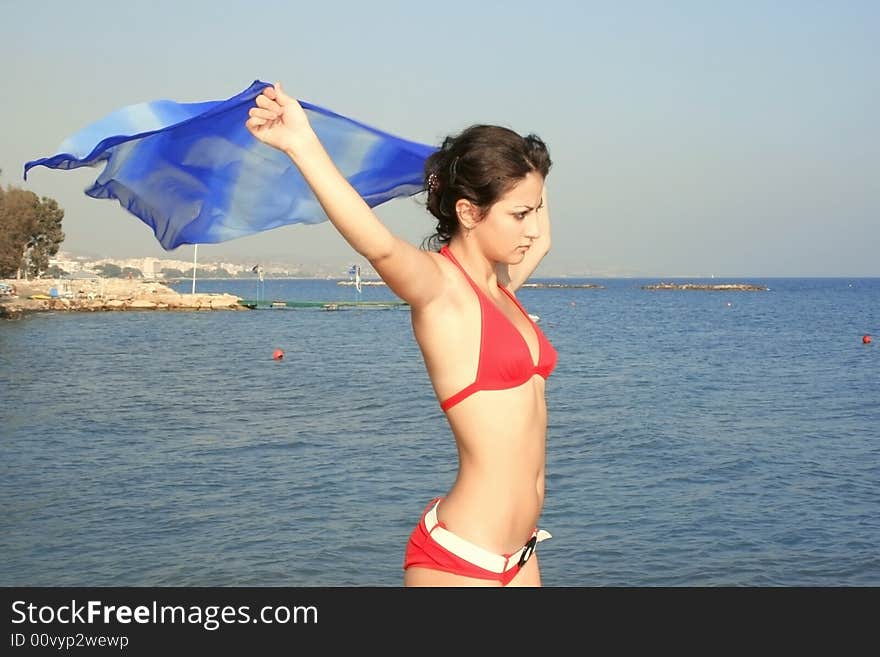 Pretty girl in red bikini on the beach.