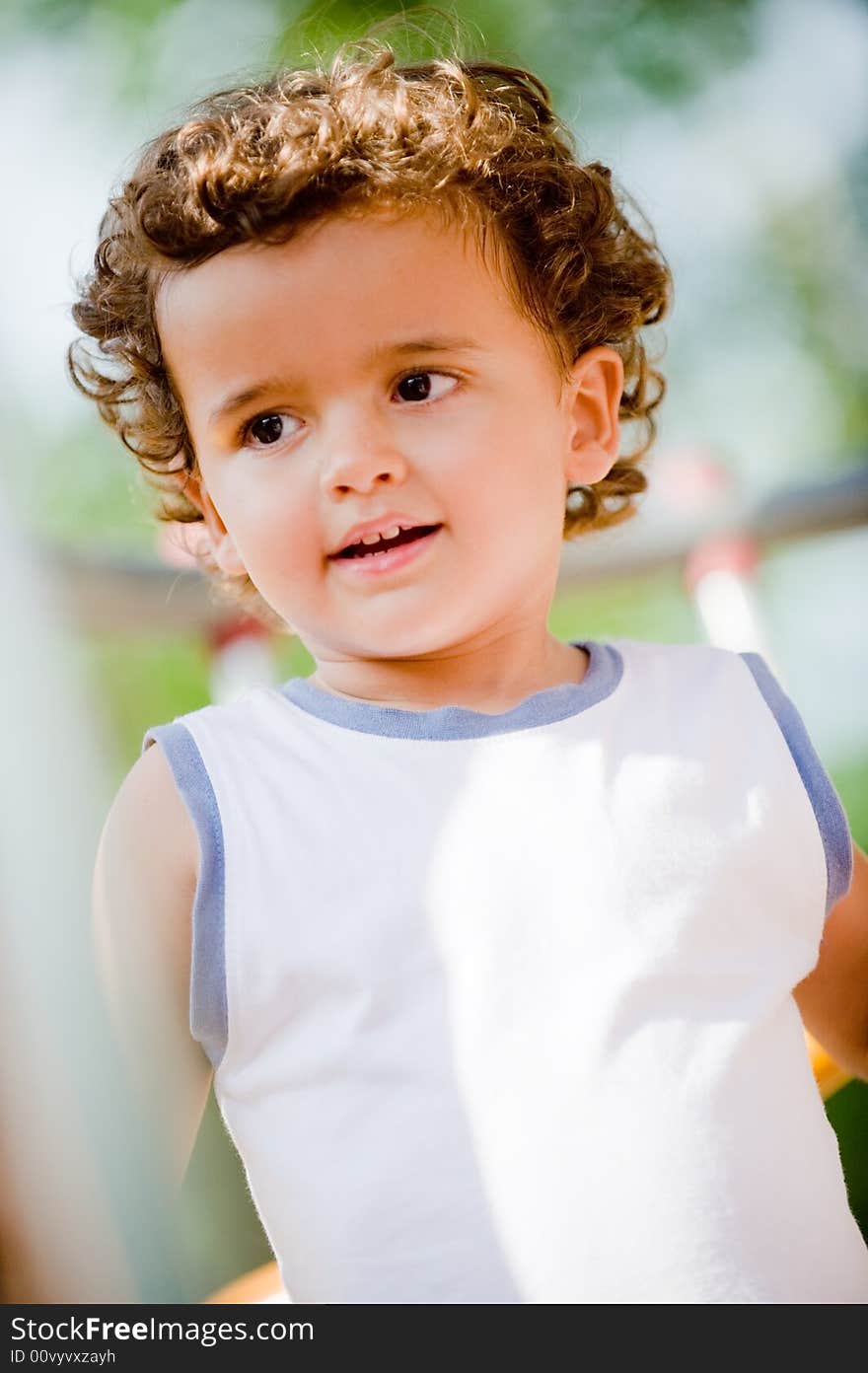 A cute young kid playing outside at the park. A cute young kid playing outside at the park