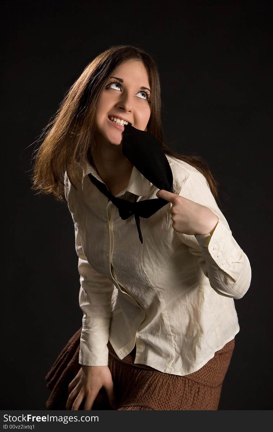 The brunette girl in a white shirt and black tie