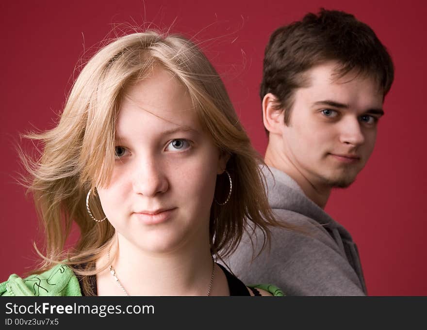 The young girl and the guy on a red background. The young girl and the guy on a red background.