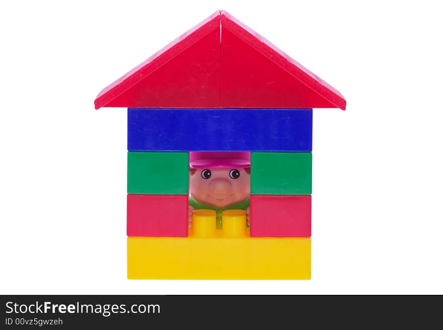 House made of blocks with toy man looking through te window. House made of blocks with toy man looking through te window