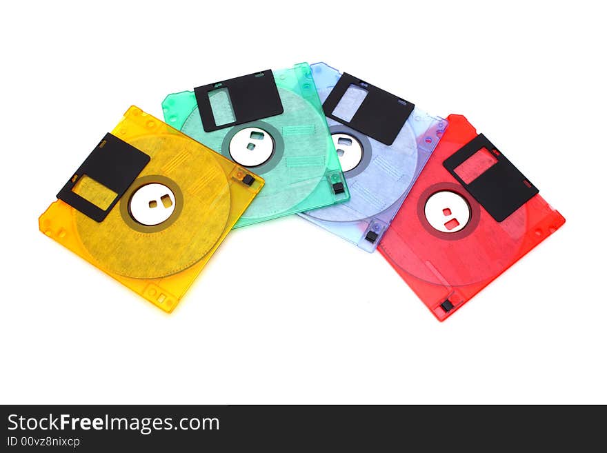 Four colorful floppy disks over a white surface