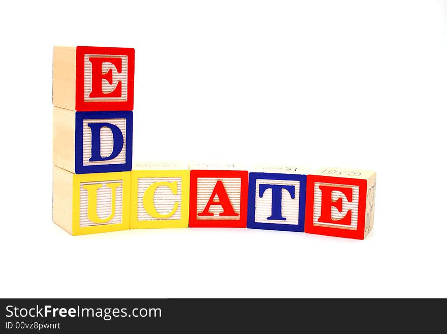 Word educate formed by letter wood blocks over a white surface