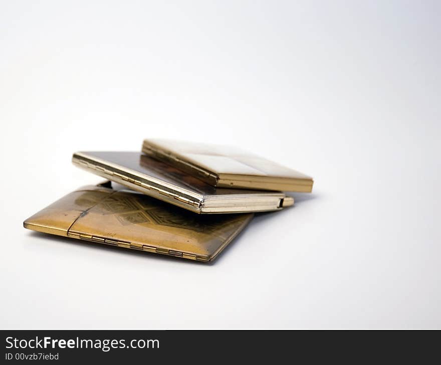 Three vintage cigarette cases on a white background. Three vintage cigarette cases on a white background.