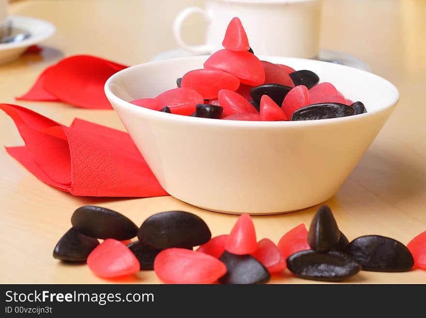 Candy with coffee cups in the background. Candy with coffee cups in the background