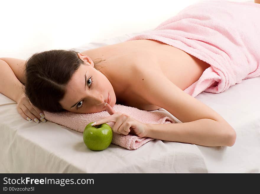 Beautiful young woman relaxing, with green apple ahead. Beautiful young woman relaxing, with green apple ahead