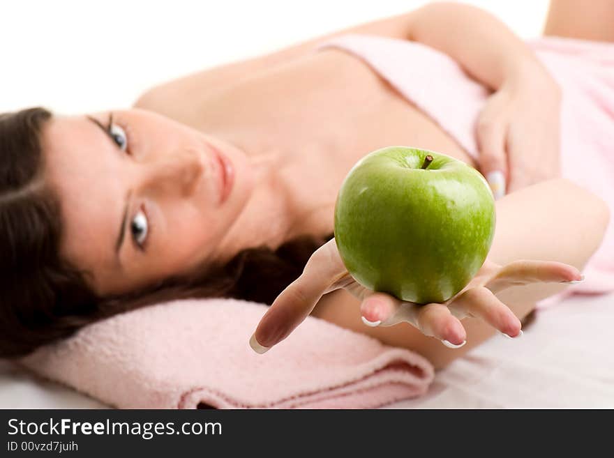 Beautiful young woman in towel holding green apple. Beautiful young woman in towel holding green apple