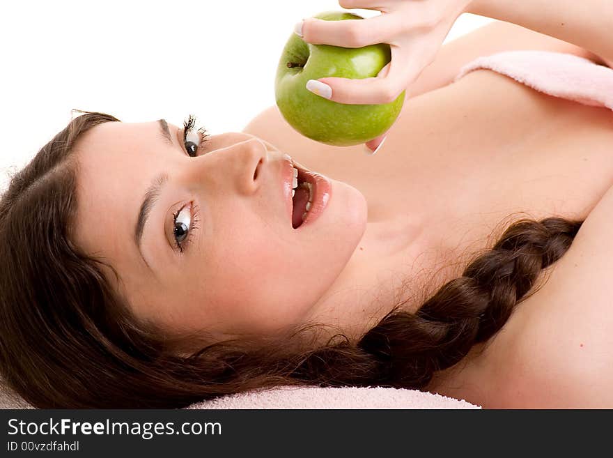 Beautiful young woman in towel holding green apple. Beautiful young woman in towel holding green apple