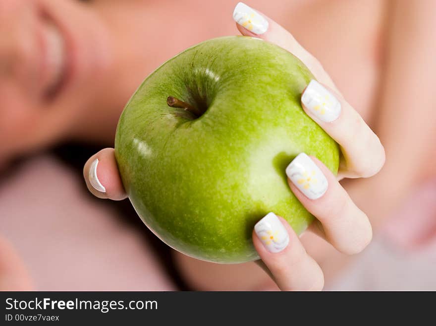 Young woman offering green apple. Young woman offering green apple