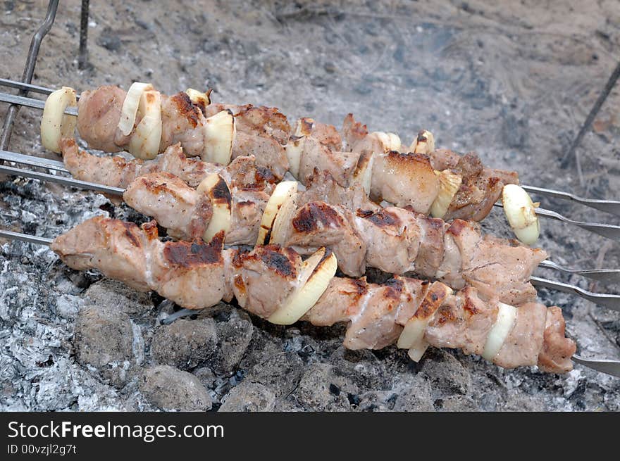 Fried on carbons meat with onion and paper. Fried on carbons meat with onion and paper