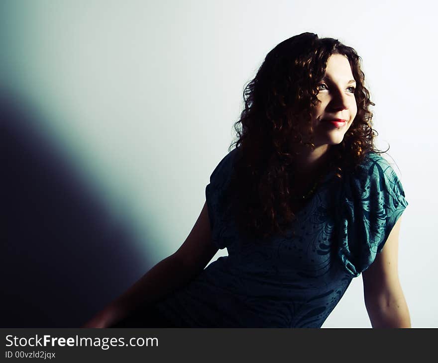 A portrait about a pretty lady with white skin and long brown wavy hair who wears a nice green dress and she is smiling. A portrait about a pretty lady with white skin and long brown wavy hair who wears a nice green dress and she is smiling