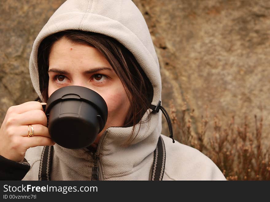 Photo of a woman resting after a long trek in the hills. Photo of a woman resting after a long trek in the hills