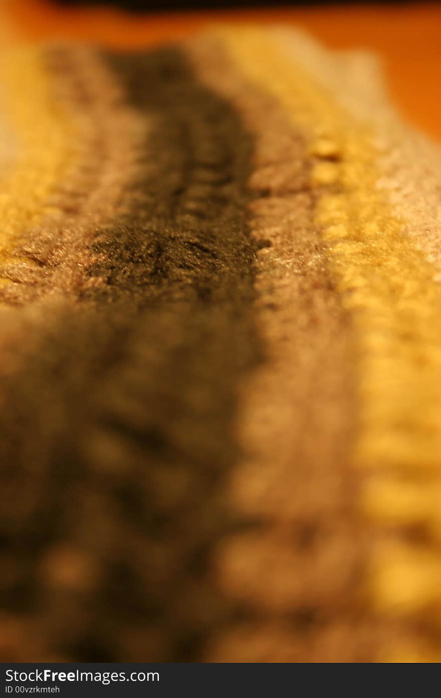 Close up photo of a woolen scarf showing the fibres of the material. Close up photo of a woolen scarf showing the fibres of the material