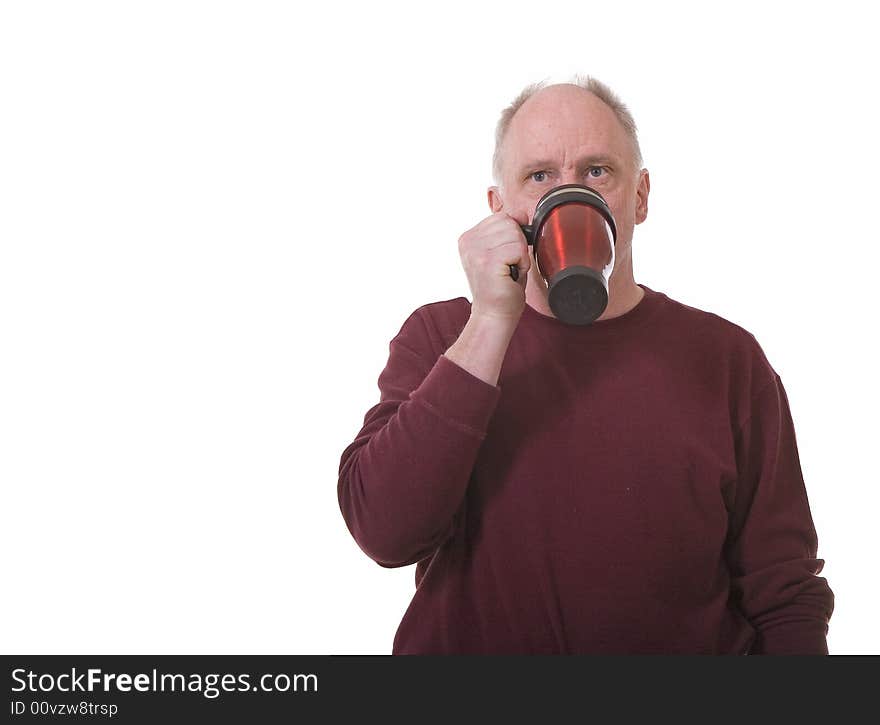 An older guy drinking coffee from a travel mug. An older guy drinking coffee from a travel mug