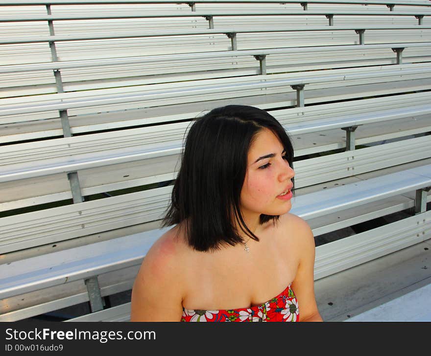 Woman sitting on the bleachers