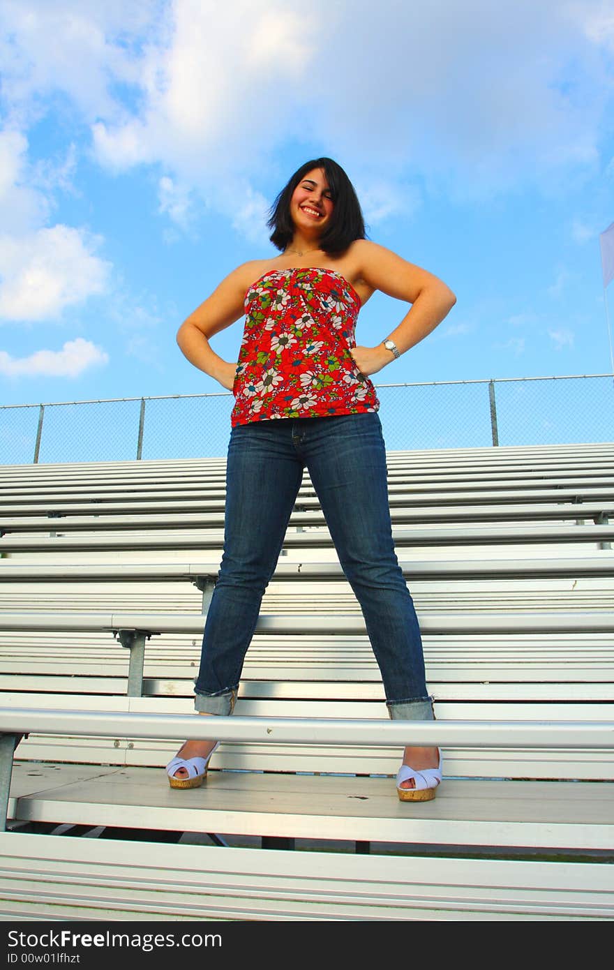 Woman standing on bleachers