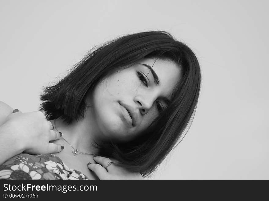 Headshot of a young woman looking at the camera. Headshot of a young woman looking at the camera.