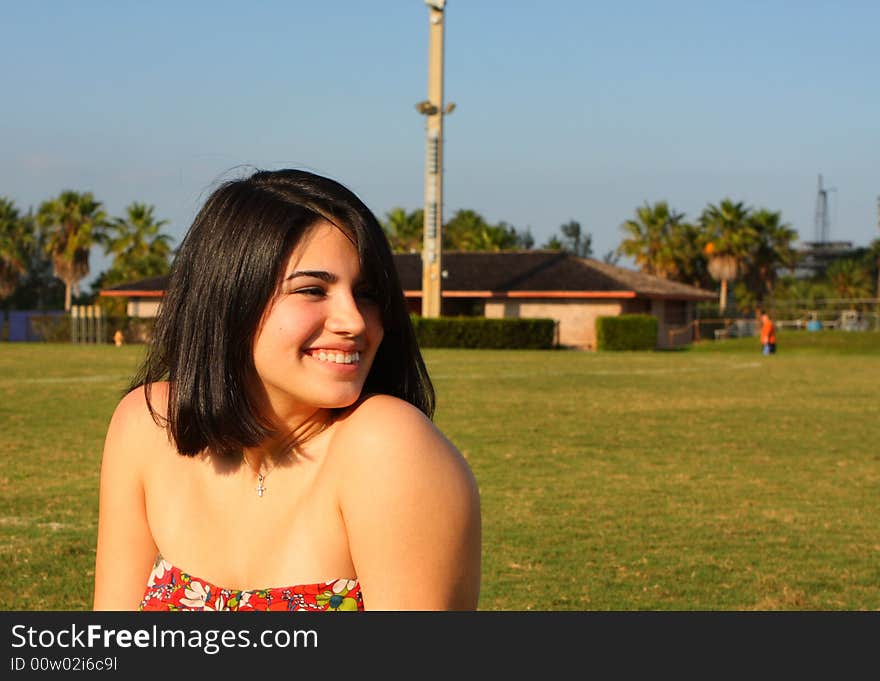 Attractive young woman looking to the side and smiling. Attractive young woman looking to the side and smiling