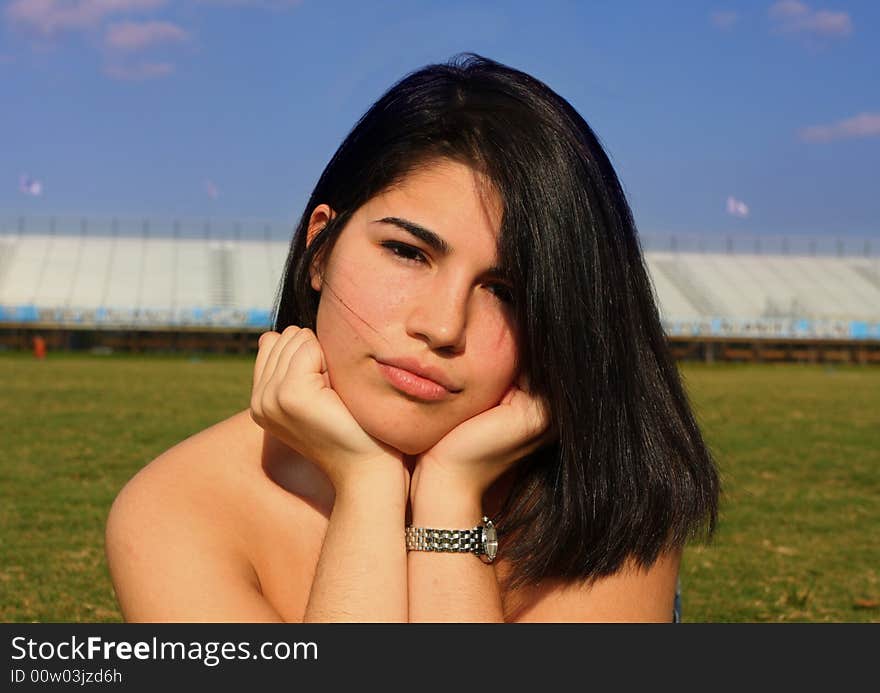 Young girl with her hands under her chin. Young girl with her hands under her chin.