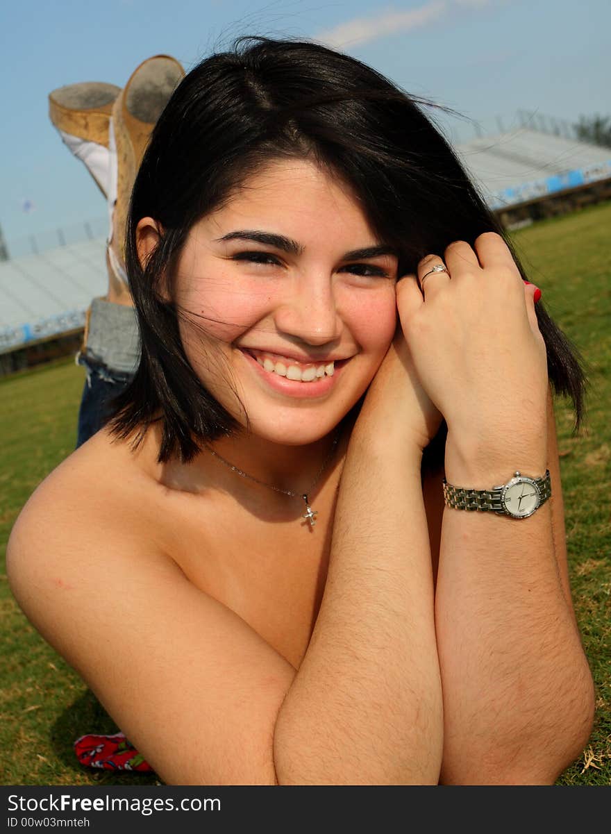 Young woman laying on grass