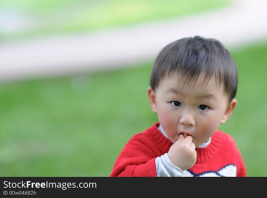 Little baby in red is eating. Little baby in red is eating.