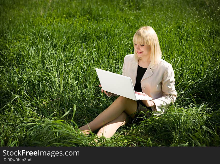 Pretty girl with notebook on the grass. Pretty girl with notebook on the grass