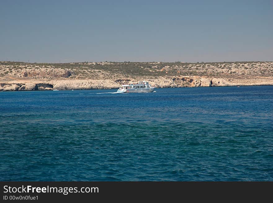 Boat on Mediterranean sea at Cape Greko, sunny day of Cyprus. Boat on Mediterranean sea at Cape Greko, sunny day of Cyprus.