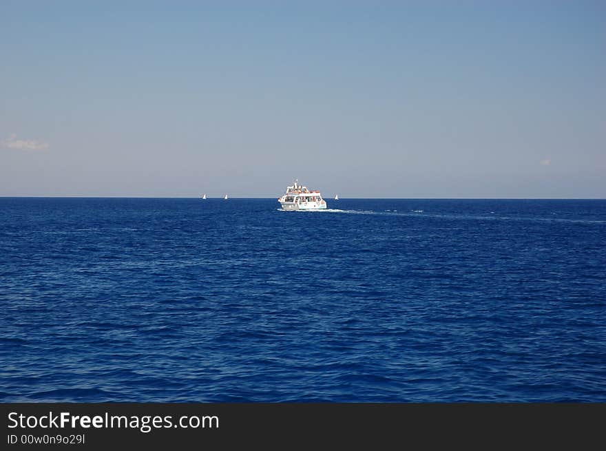 Boat on Mediterranean sea at Cape Greko, sunny day of Cyprus.