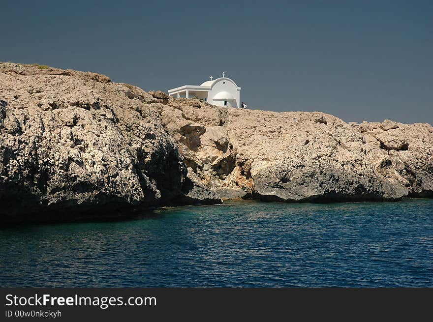 Greek church on Cliffs and the Mediterranean sea. Greek church on Cliffs and the Mediterranean sea