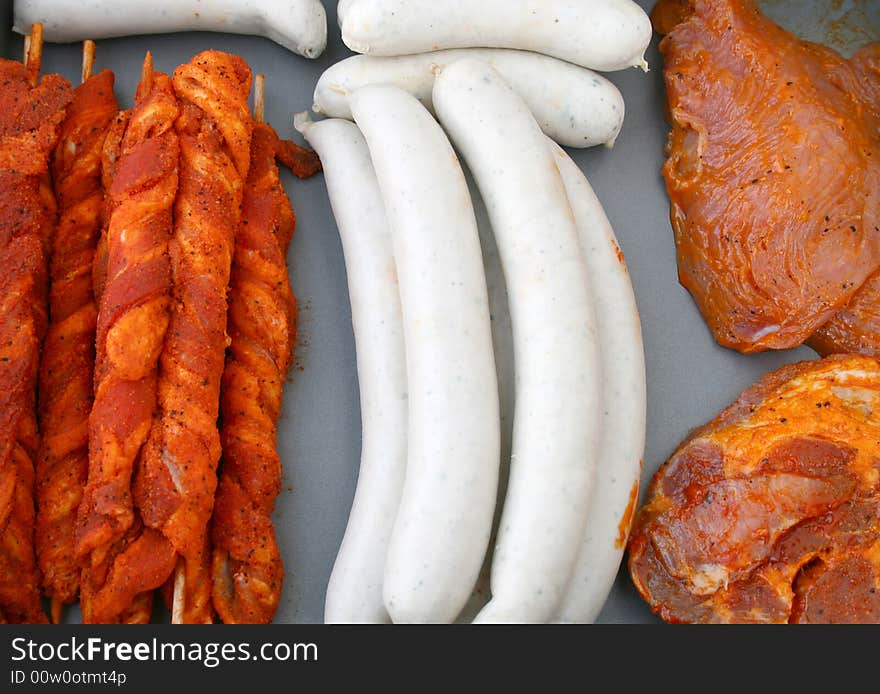 Raw barbecue meat and sausages