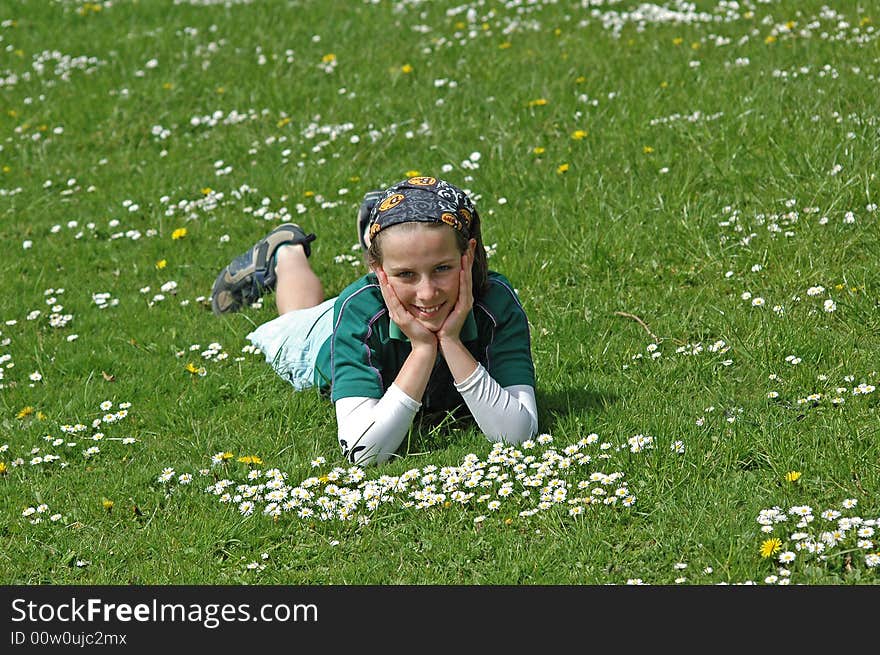 Young Girl Lying In Grass In Springtime