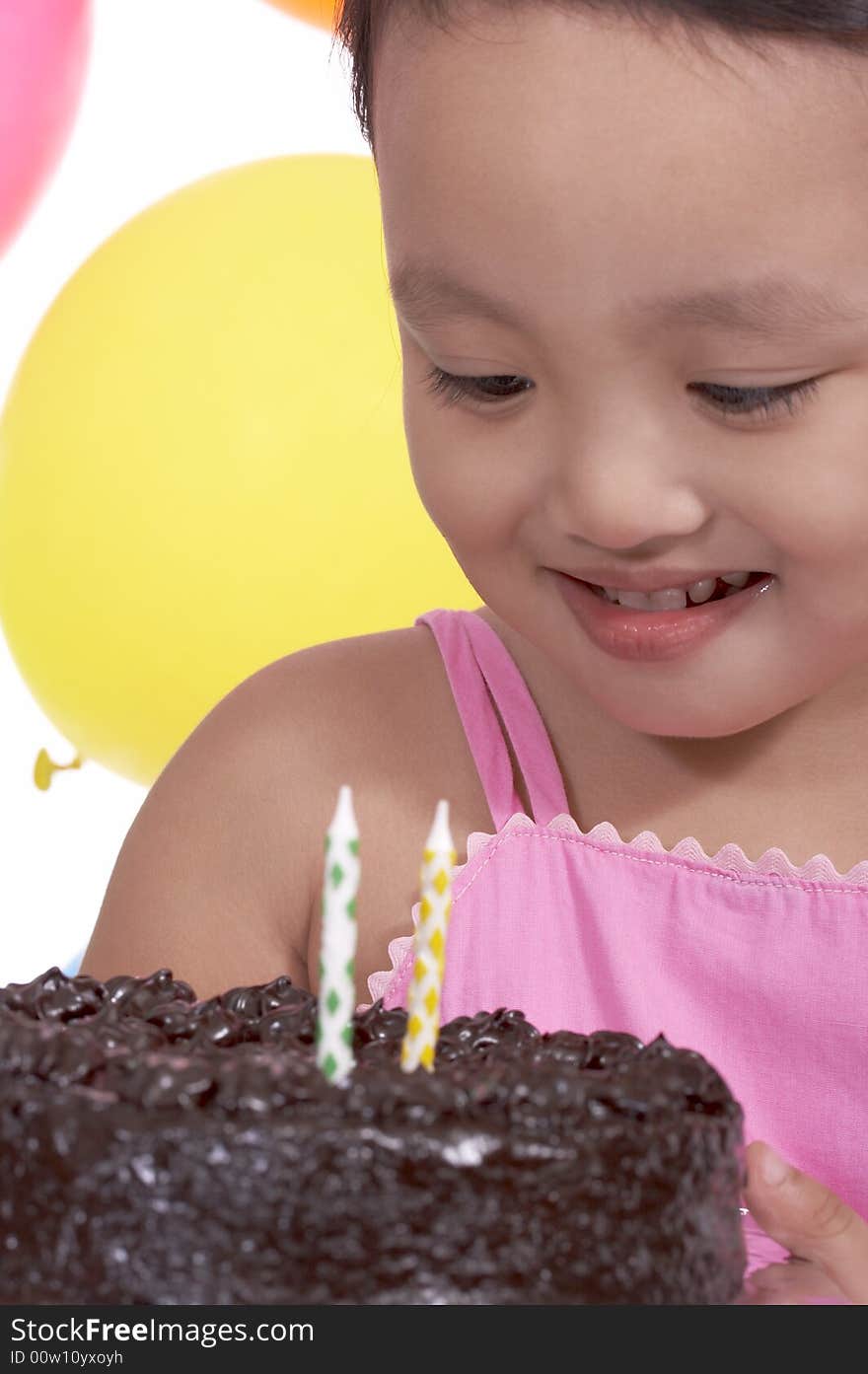 Happy child holding a delicious chocolate cake