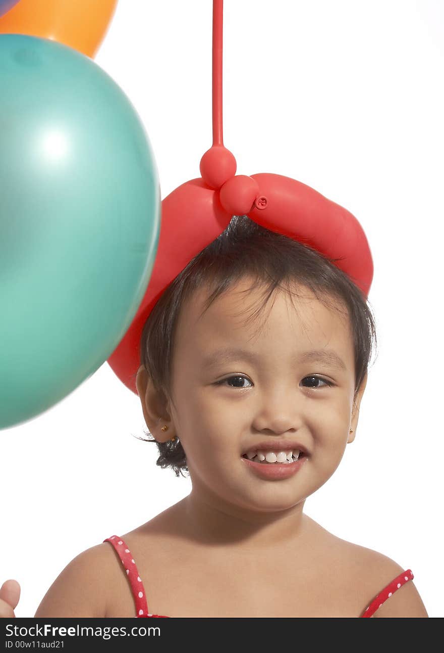 Smiling little girl and her colorful balloons