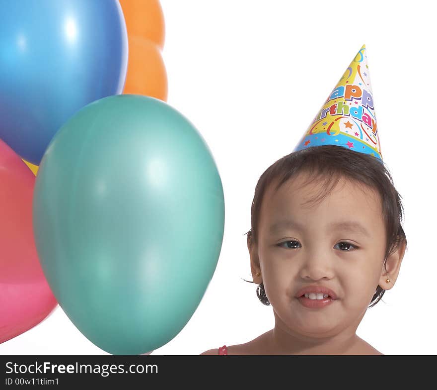 Birthday girl with party hat and colorful balloons