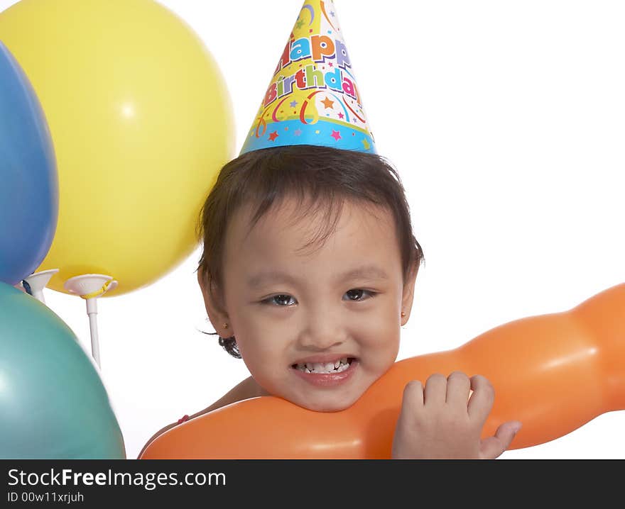 Happy child with party hat and colorful balloons