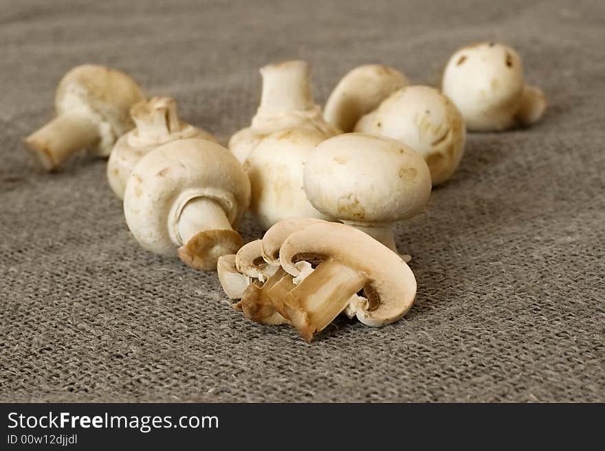 Table mushrooms, sliced, close-up, shot on textile background