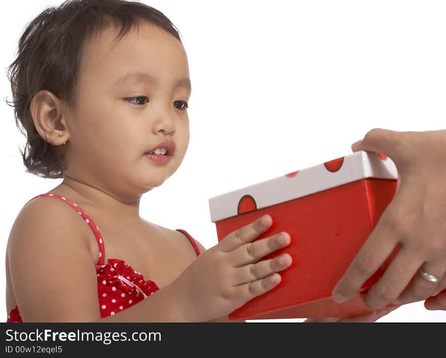 Little young girl holding a red gift box