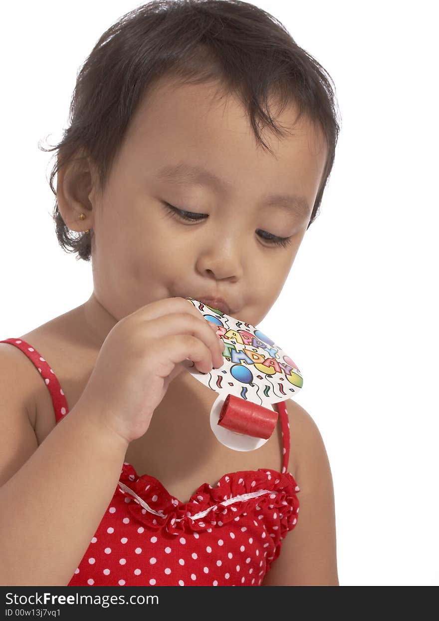 Attractive little girl holding a party popper