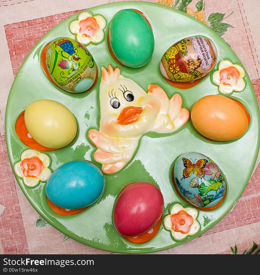 Colored easter eggs on the green plate