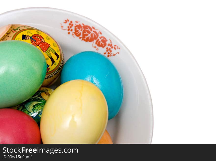 Colored easter eggs on the plate white isolated