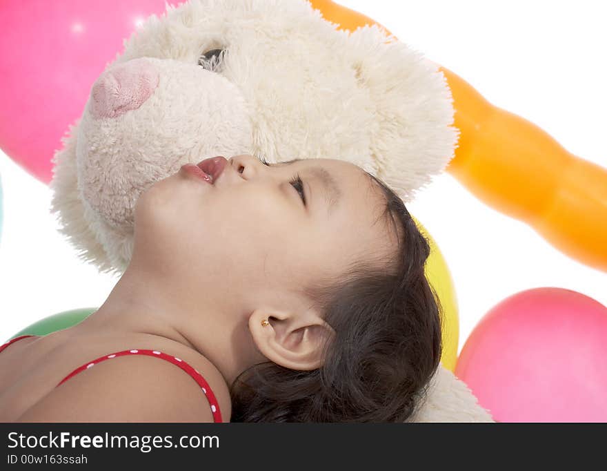 Child looking up with teddy bear on a white background