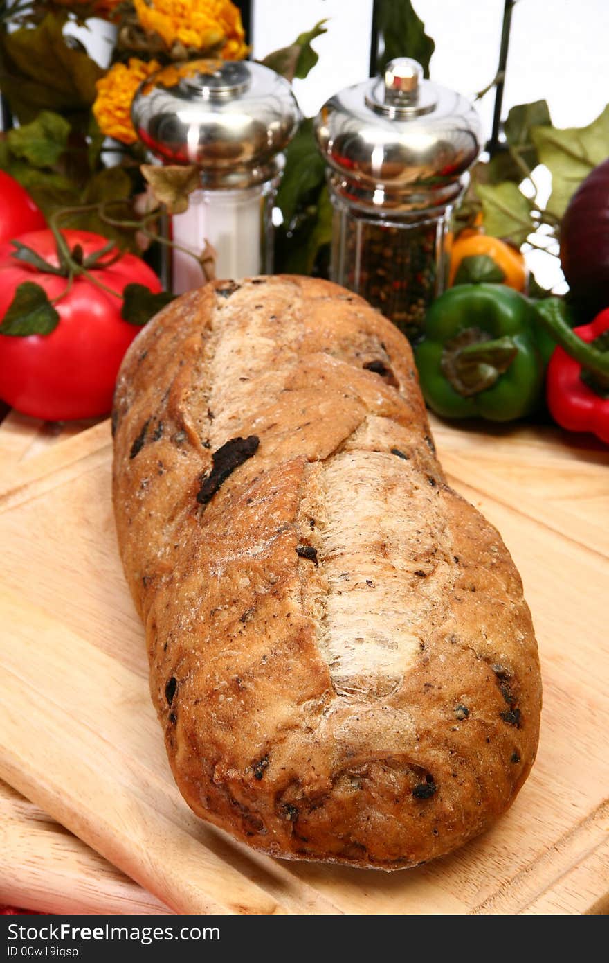 Whole olive bread loaf with parsley butter in kitchen or restaurant. Whole olive bread loaf with parsley butter in kitchen or restaurant.