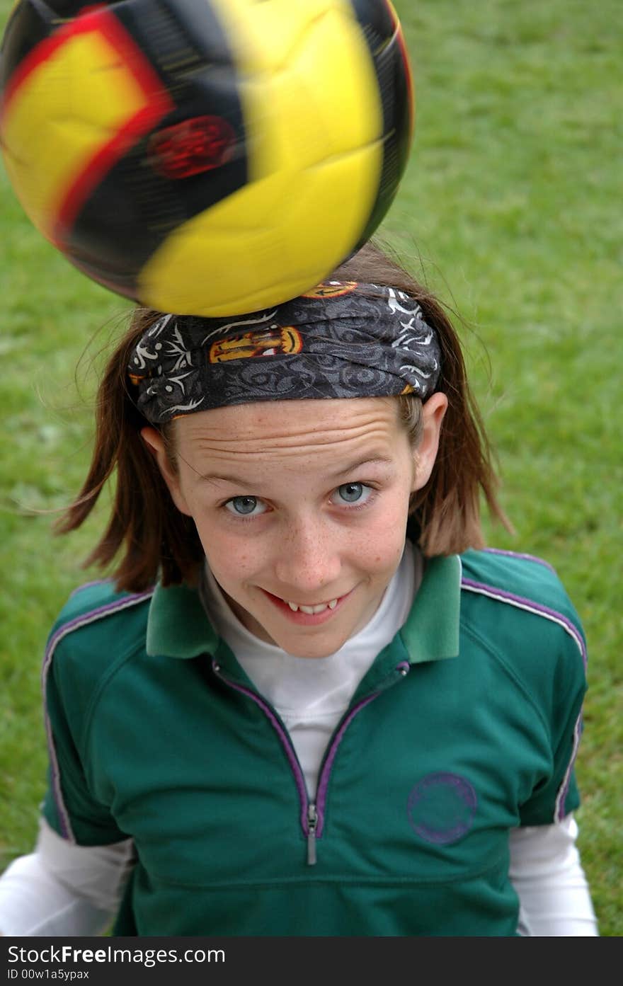 Close-up of child balancing ball on her head. Close-up of child balancing ball on her head