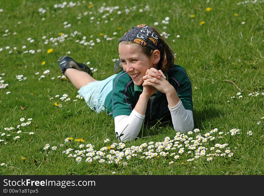 Child lying in the grass in spring