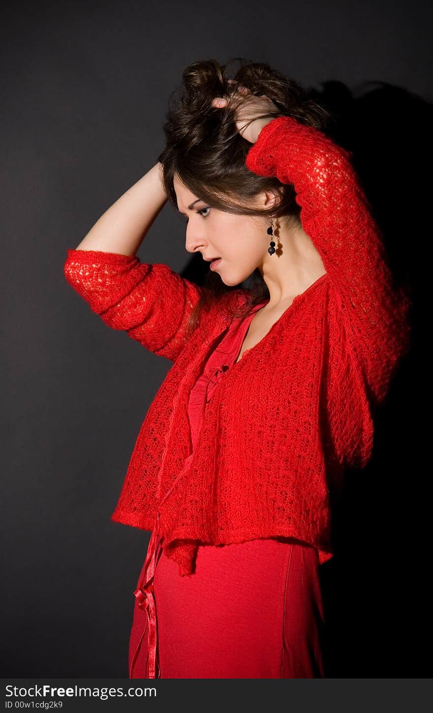 Disappointed girl. red dress. black background